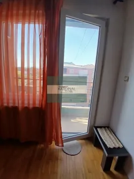 Balcony door with access to the terrace and a view of surrounding buildings. - image 5