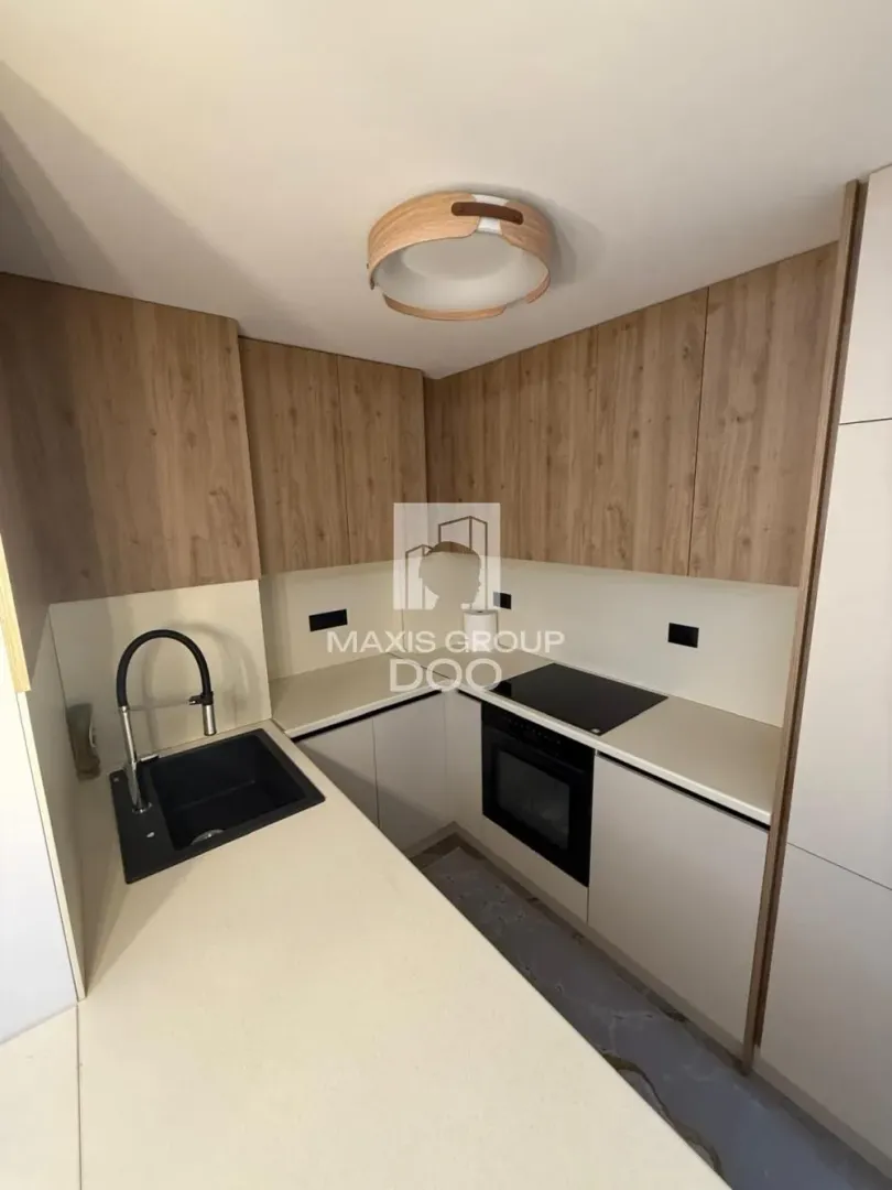Small kitchen with built-in units and sink.