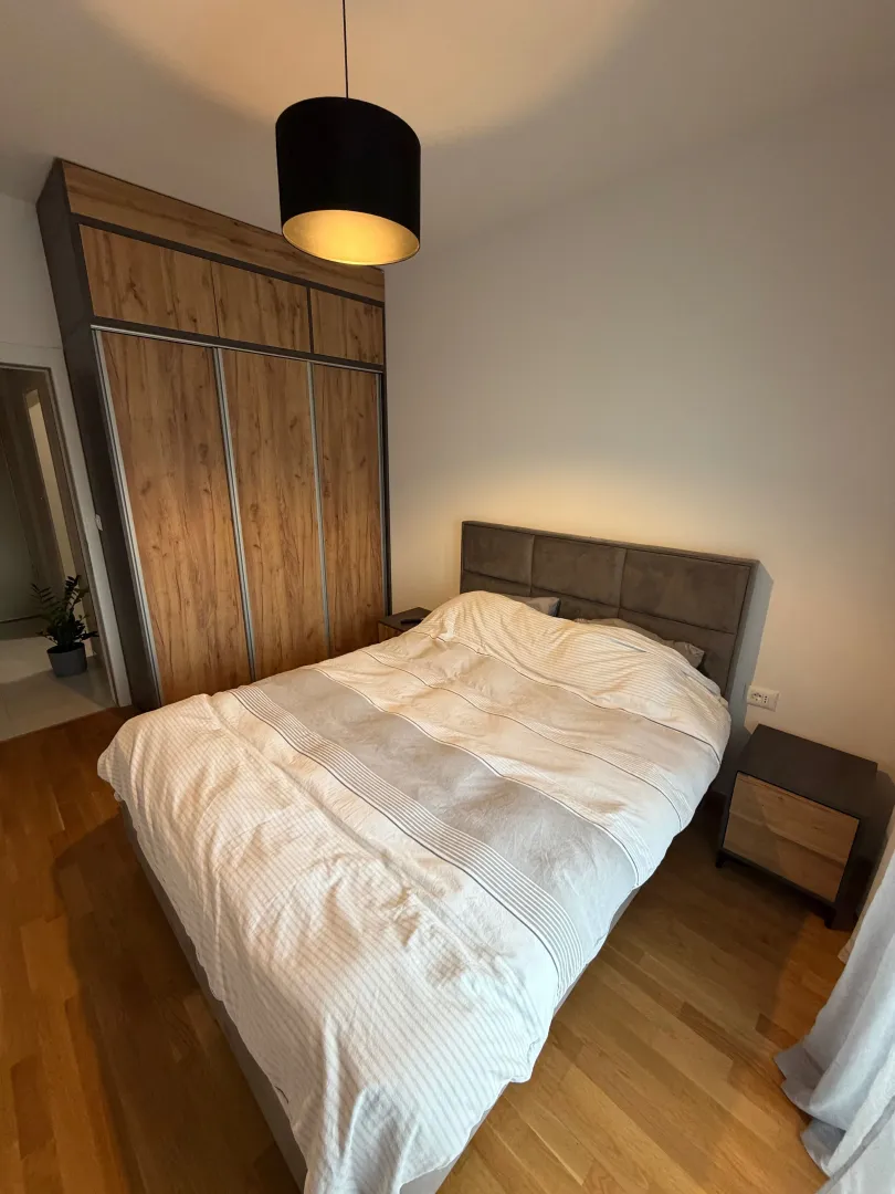 Modern bedroom with a double bed and built-in wardrobe.