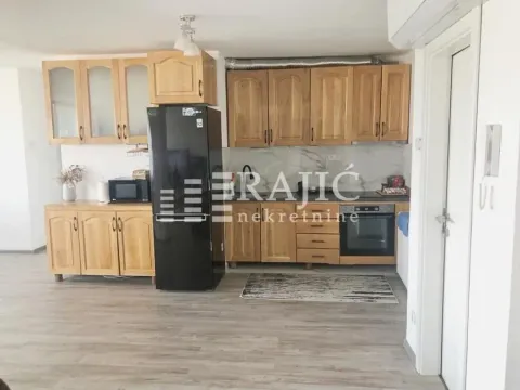 Wooden kitchen cabinets with a black refrigerator and built-in oven. - image 7