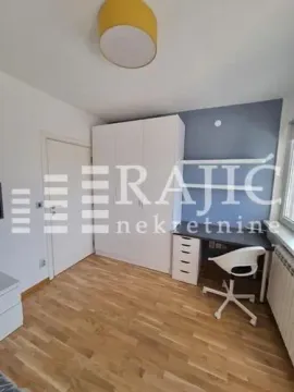 Furnished bedroom with a desk and wardrobe. - image 3
