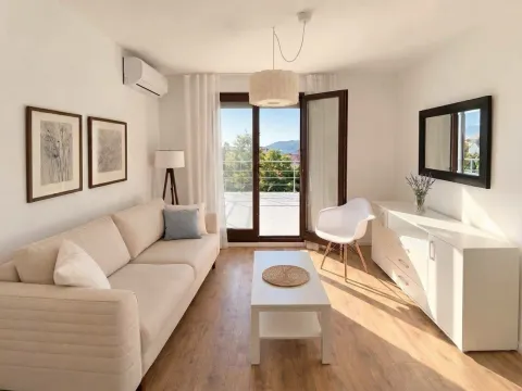 Bright and neatly furnished living room with access to the terrace. - image 3