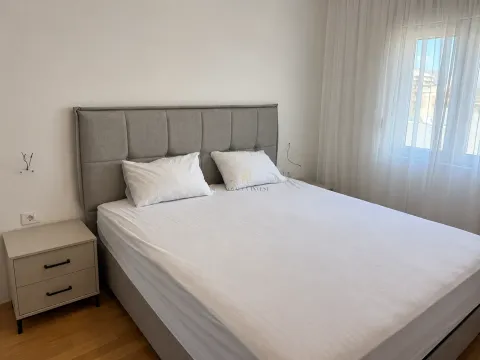 Bedroom with a double bed, headboard, and a bedside table next to the window. - image 4