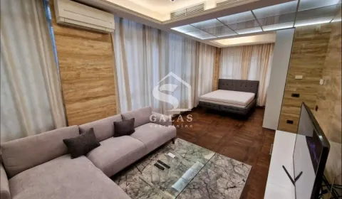 Spacious bedroom with a double bed, sofa seating area and TV. - image 2