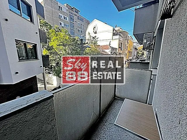 View from the balcony overlooking surrounding buildings and the street.