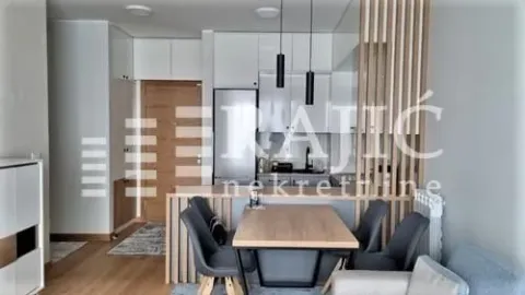 Living room with dining area and kitchen in bright tones. - image 3