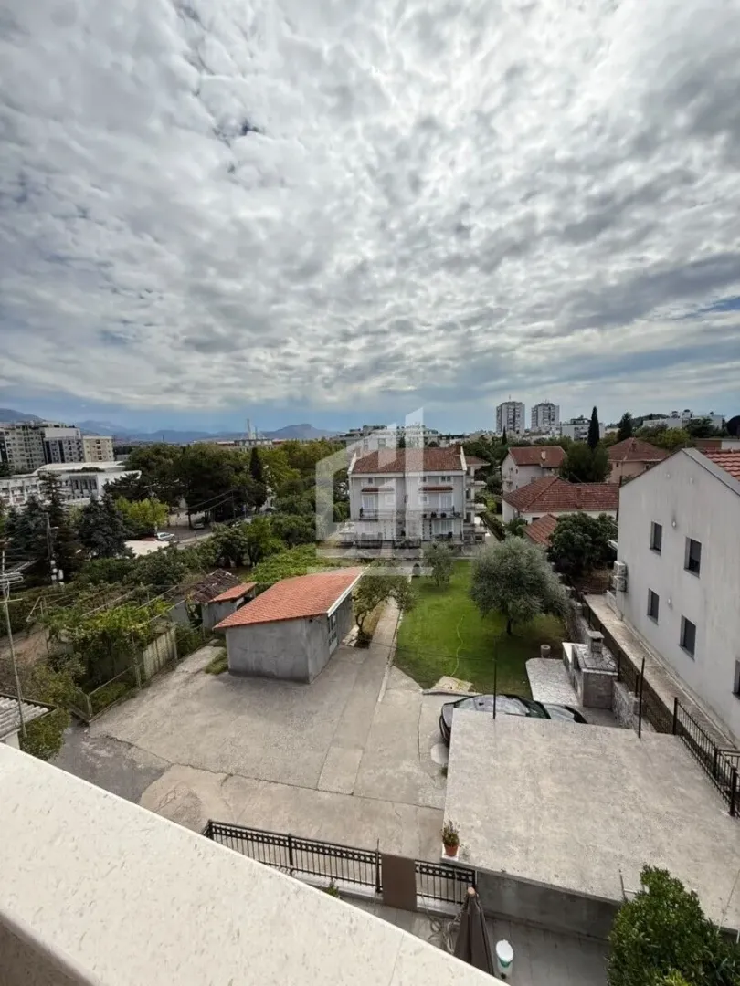 View from the terrace overlooking the courtyard, surrounding buildings, and cityscape.