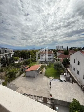 View from the terrace overlooking the courtyard, surrounding buildings, and cityscape. - image 5