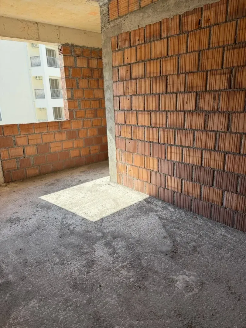 Unutrašnjost stana u izgradnji sa zidovima od cigle.