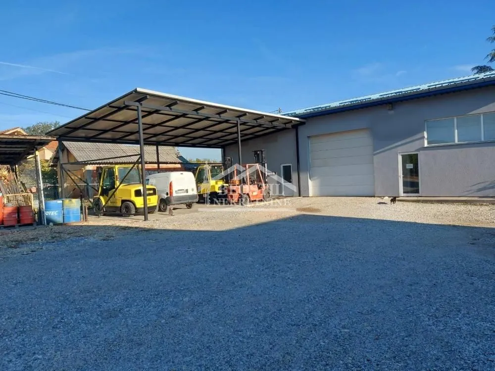 View of the exterior of a commercial building with a canopy and maneuvering area.