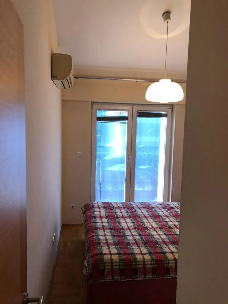 View of the bedroom with a bed and a window.