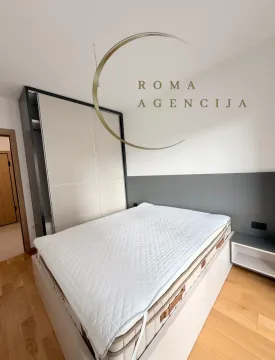 Furnished bedroom with a double bed and built-in wardrobe. - image 7