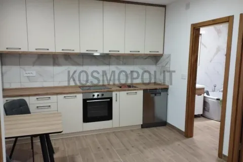 Kitchen with built-in appliances and a dining table. - image 2