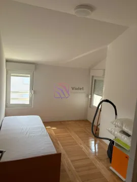 Smaller bedroom with a bed and two windows. - image 5