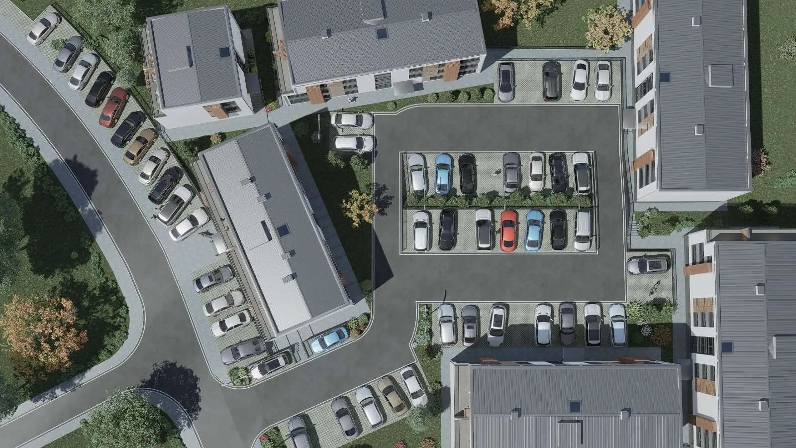 Pogled iz vazduha na stambeni kompleks sa uređenim parking prostorom.