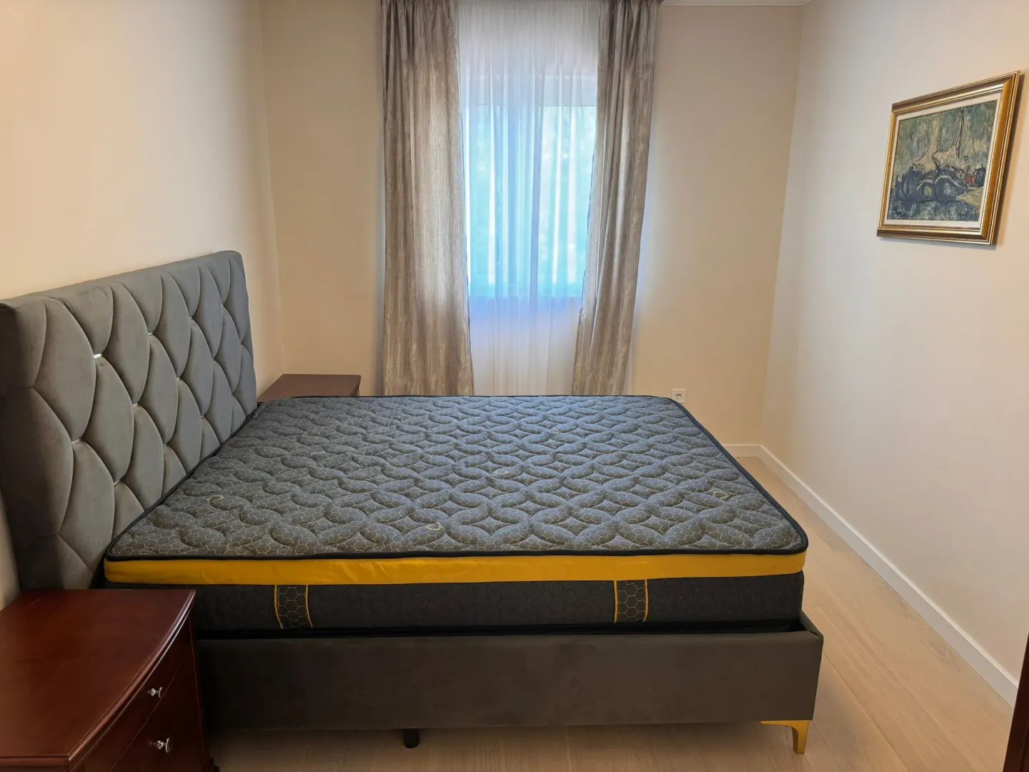 Furnished bedroom with a double bed and a window.