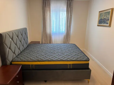 Furnished bedroom with a double bed and a window. - image 3