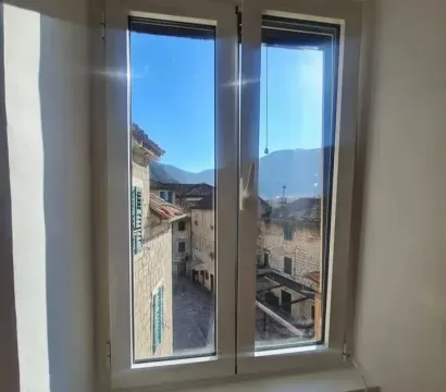 View through the window overlooking the old town street and surrounding mountains. - image 6