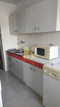 View of a small kitchen with light-colored cabinets and appliances. - image 3