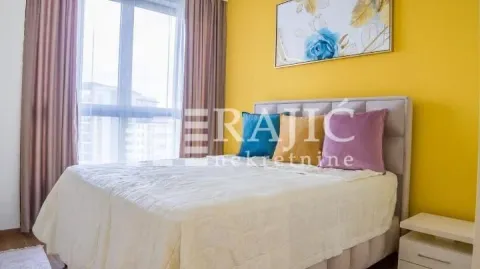Furnished bedroom with a double bed and a yellow wall. - image 4