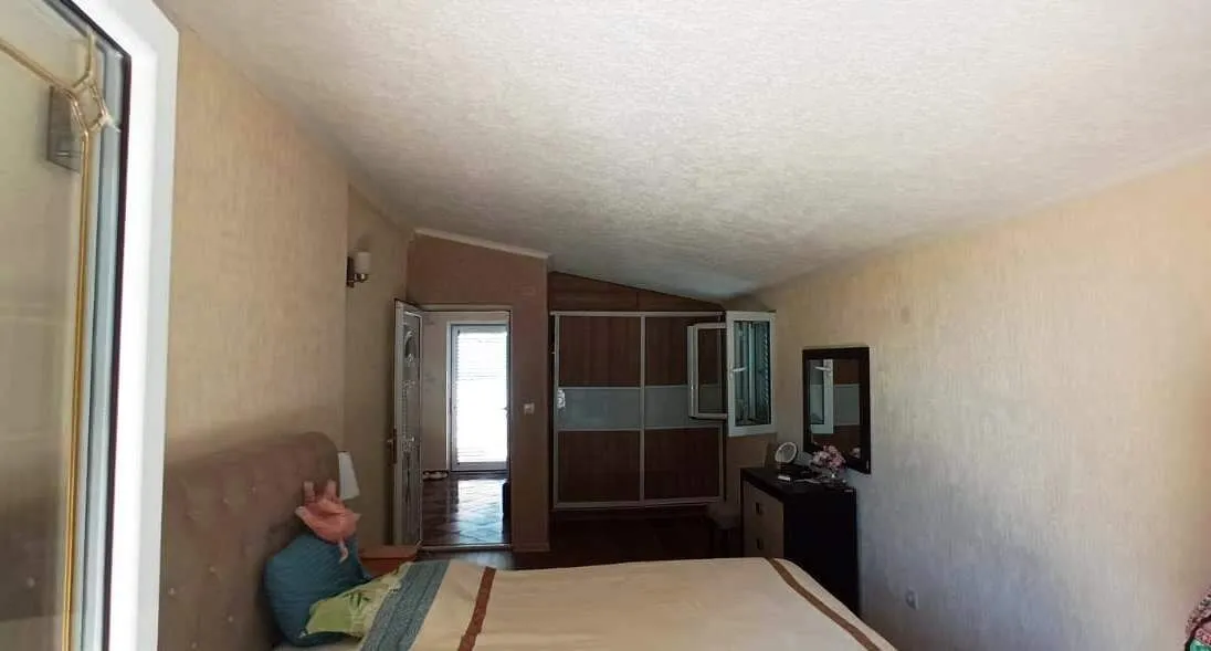 Furnished bedroom with a double bed and wardrobe.