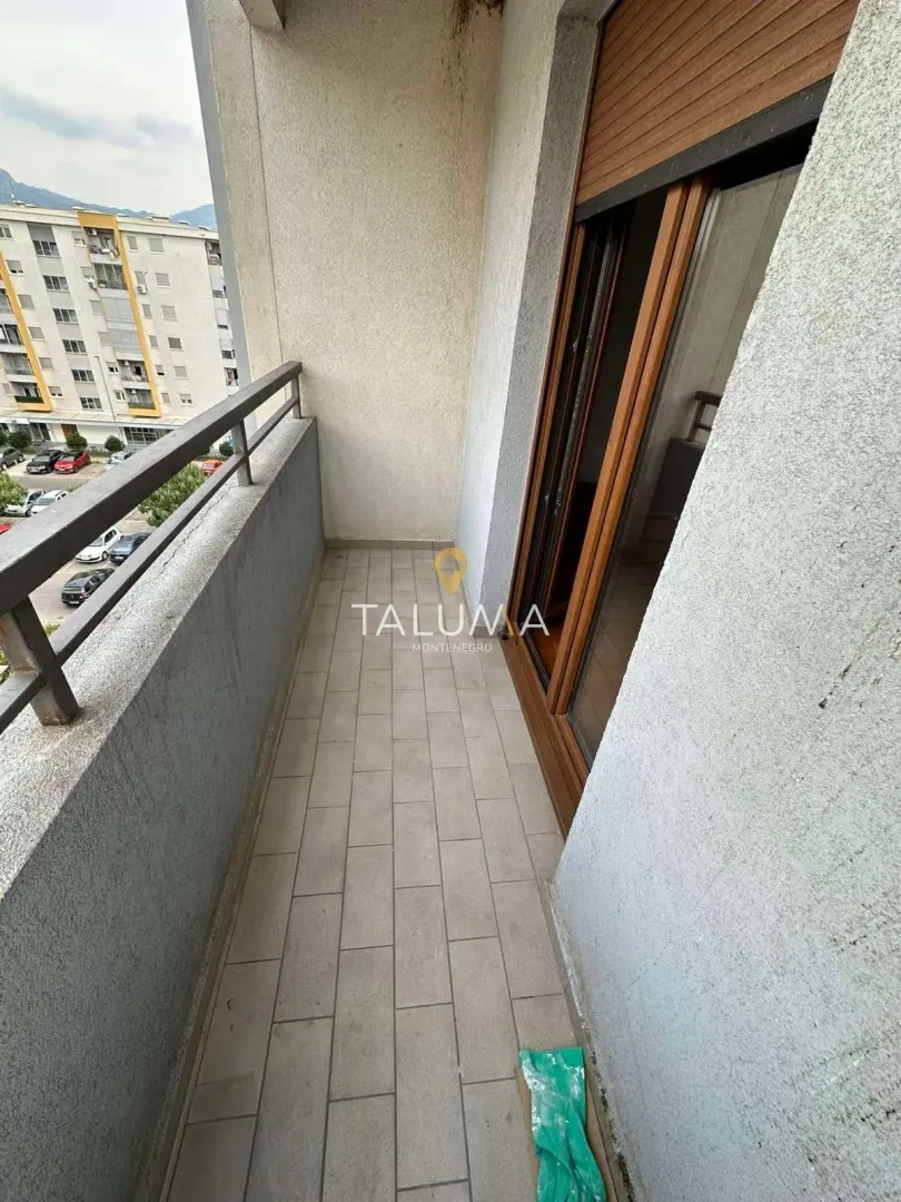 Smaller covered balcony with a view of the street and surrounding buildings.