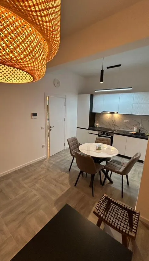 Modern kitchen with dining area and built-in appliances.