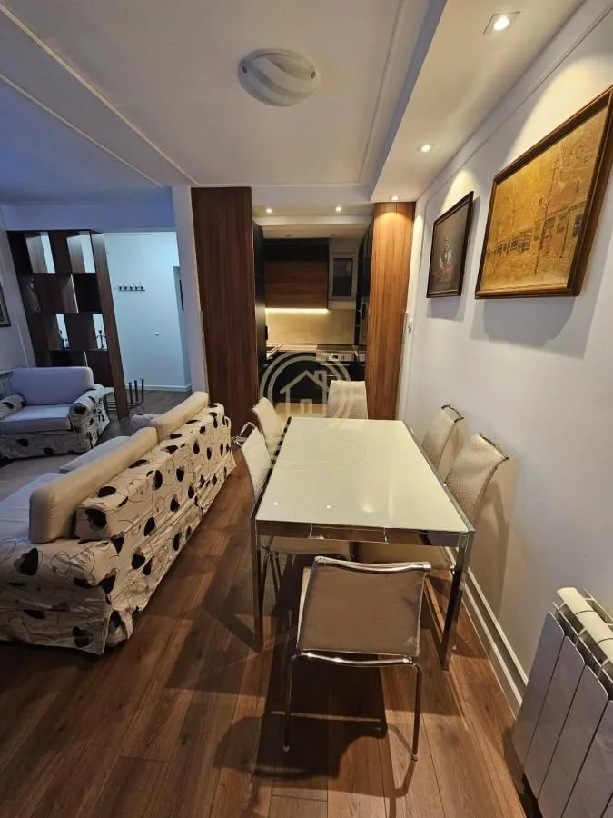 Living room with dining area and a view towards the kitchen.