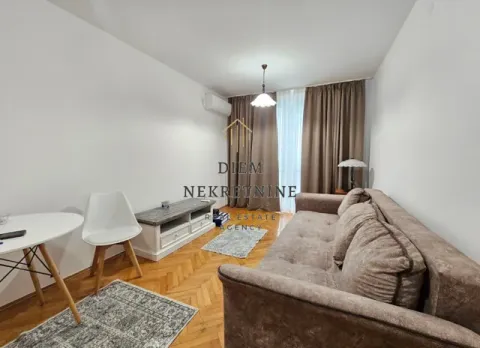 Living room with a sofa set, dining table, and window with curtains. - image 2