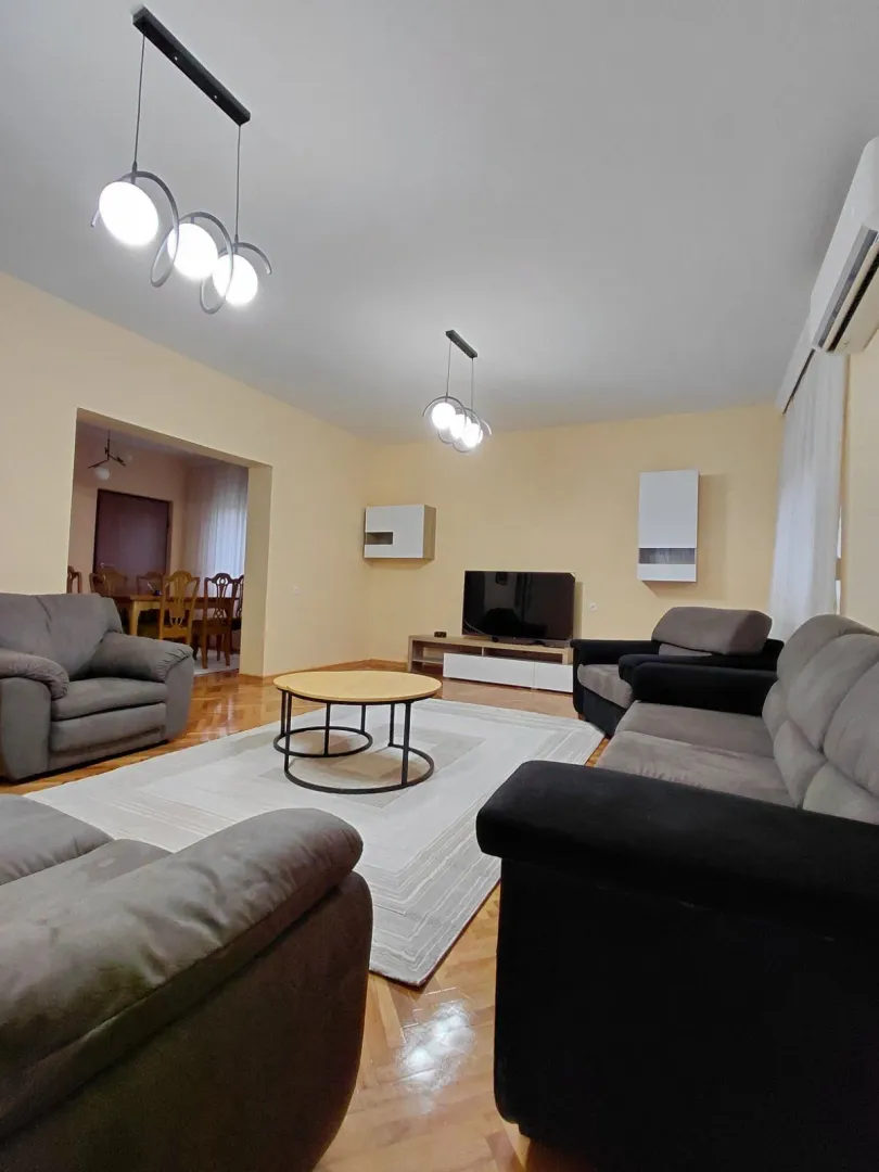 Spacious living room with seating set and view of the dining area.