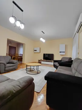 Spacious living room with seating set and view of the dining area. - image 2