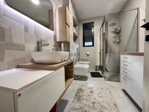 Modern and clean bathroom with a washbasin, shower cabin, and sanitary fixtures. - image 7