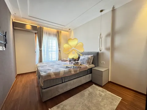 A furnished bedroom with a double bed and a window with curtains. - image 11