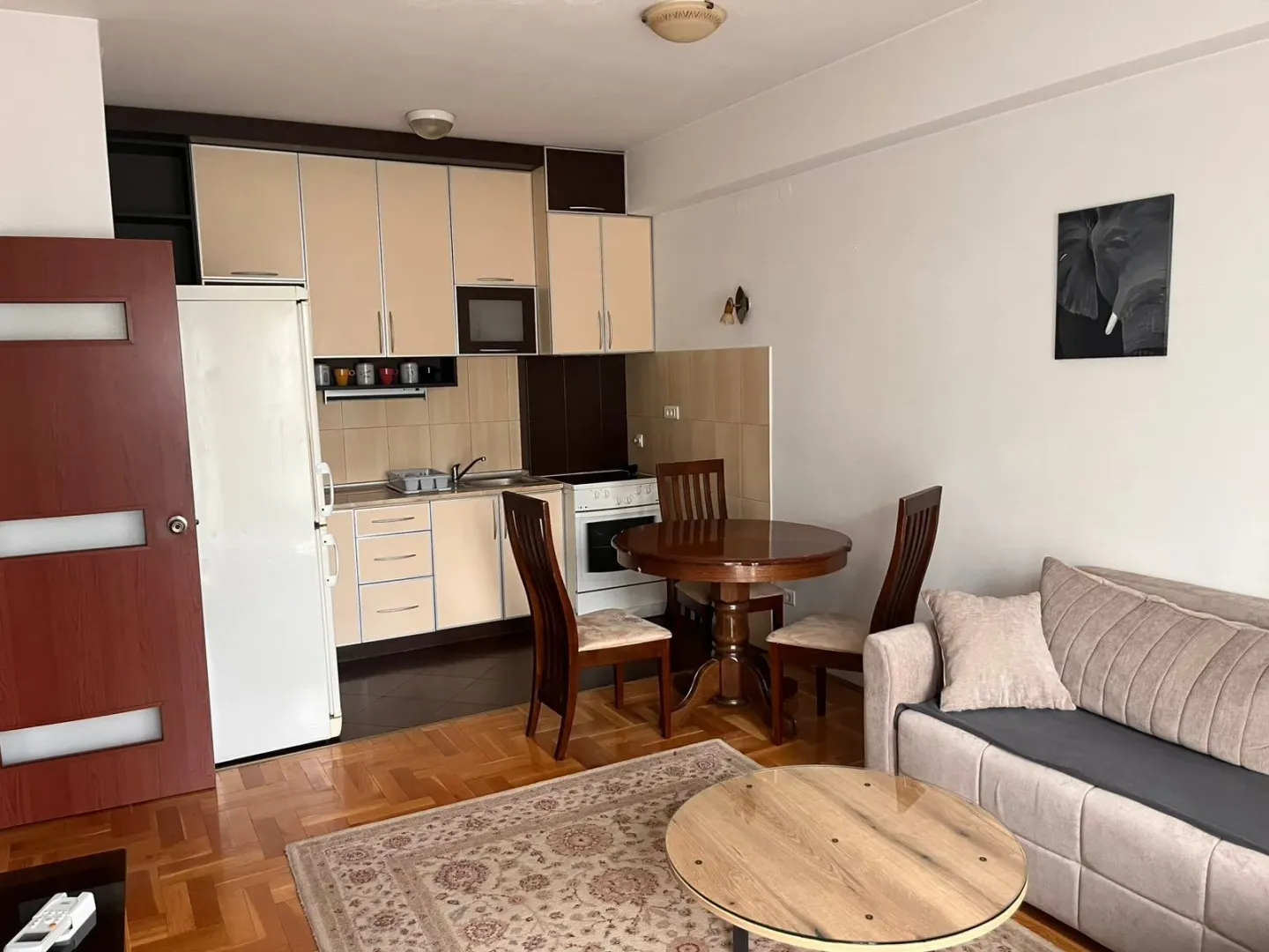 Living room with dining area and kitchen in an open space layout.