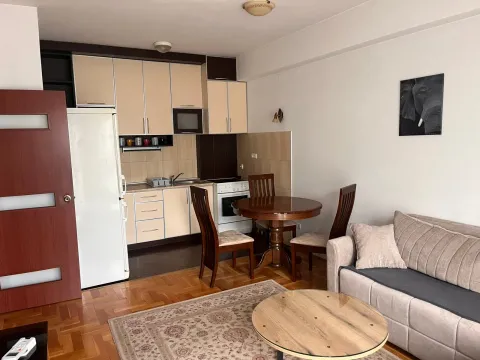 Living room with dining area and kitchen in an open space layout. - image 2