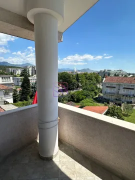 Covered balcony with a view of the city and surroundings. - image 20