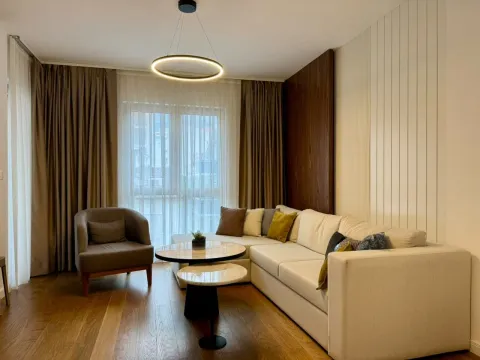 Modern and bright living room with a sectional sofa, armchair, and coffee table. - image 20