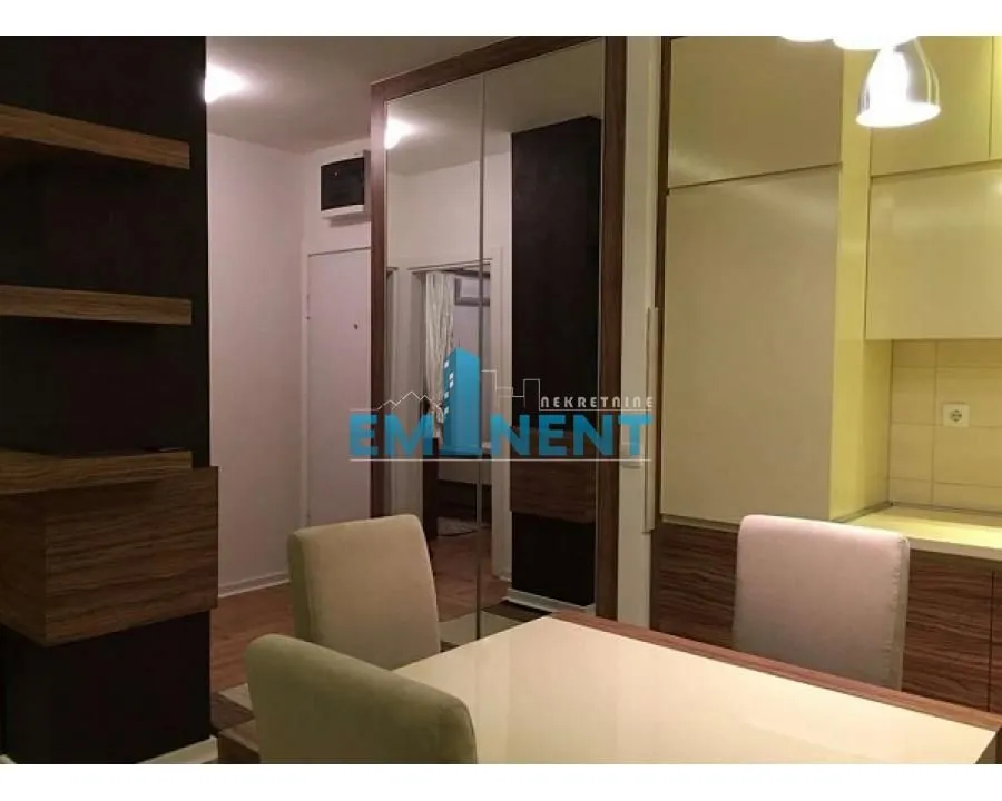 Dining area with a table and chairs connected to the kitchen.
