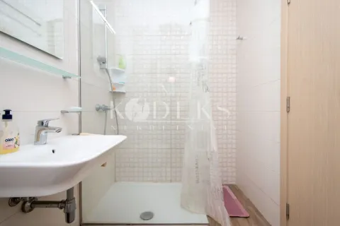 Small bathroom with a washbasin and a shower cabin. - image 10