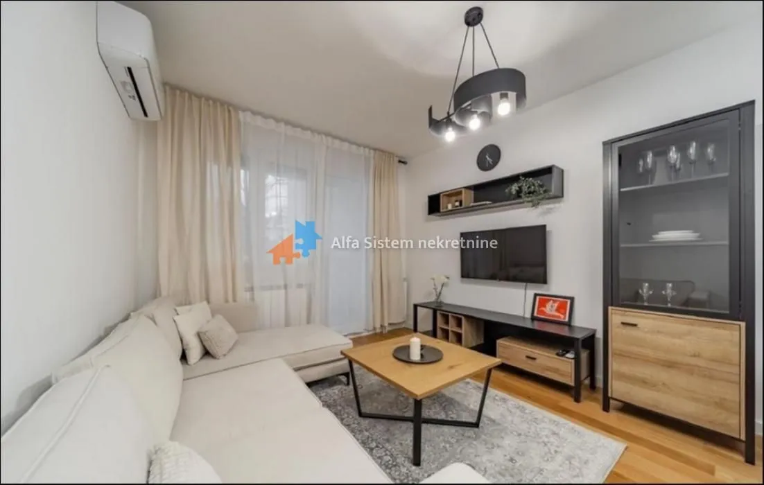 Living room with a sofa set, TV, and a cabinet.