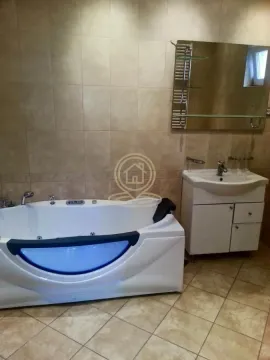 Bathroom equipped with a hydromassage bathtub, vanity unit, and mirror. - image 11