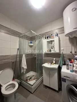 Kupatilo opremljeno tuš kabinom, umivaonikom, WC šoljom i veš mašinom. - image 2