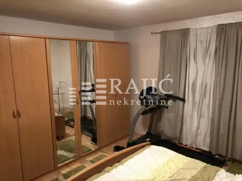 Bedroom with large wardrobes and a treadmill. - image 10