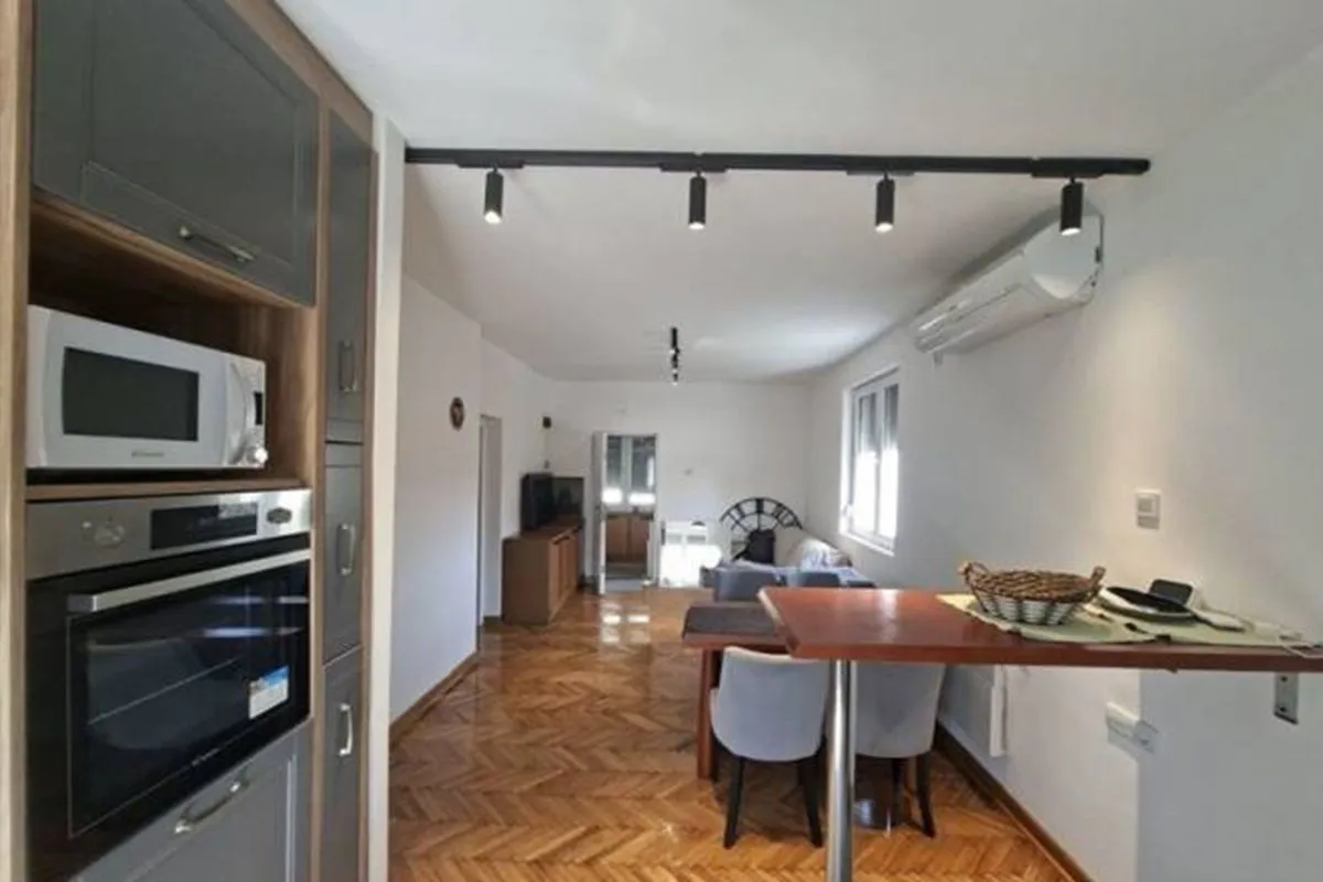 Long kitchen space with built-in units extending into the dining area.