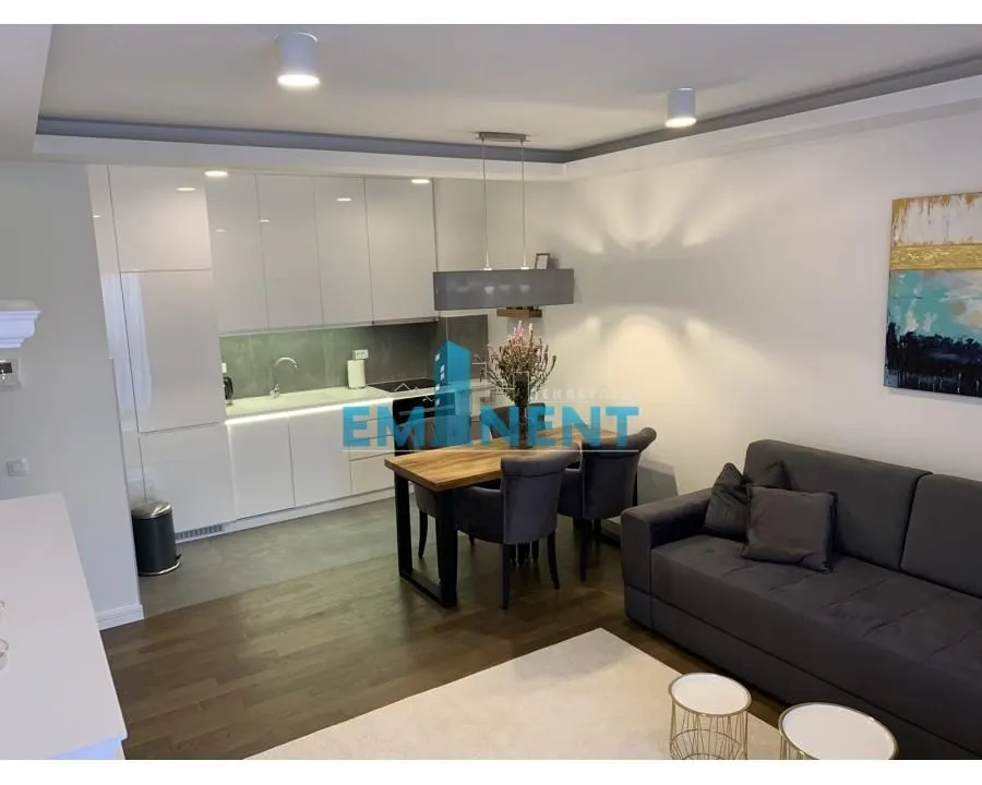 Living room with dining area and open kitchen.