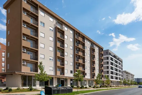 Exterior of modern residential buildings with a landscaped street and greenery. - image 8