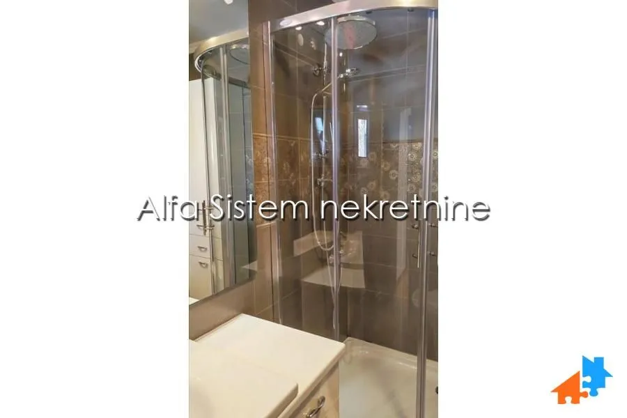 Bathroom with a shower cabin and a sink.