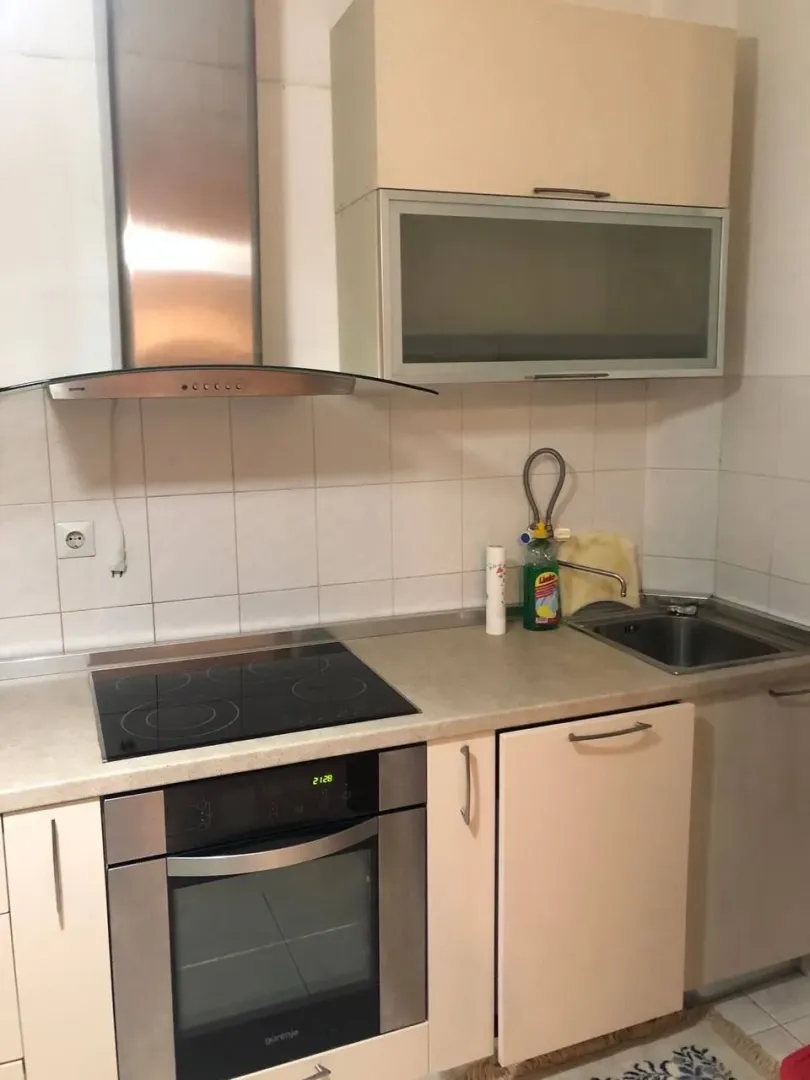 Small kitchen with built-in hob, oven, and sink.