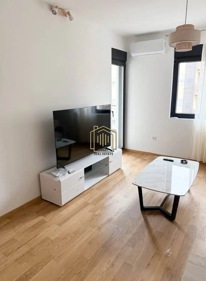 Living room with a television, low TV unit, and a coffee table.