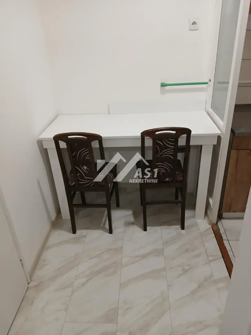 Smaller dining table with two chairs in the kitchen.